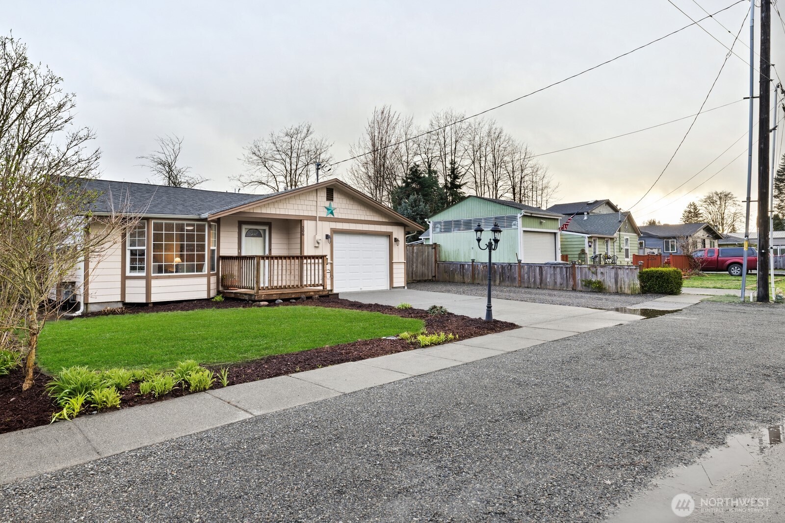506 Train Street Southeast Orting, WA 98360 - Photo 4 of 24 a view of a big house with a big yard and large tree