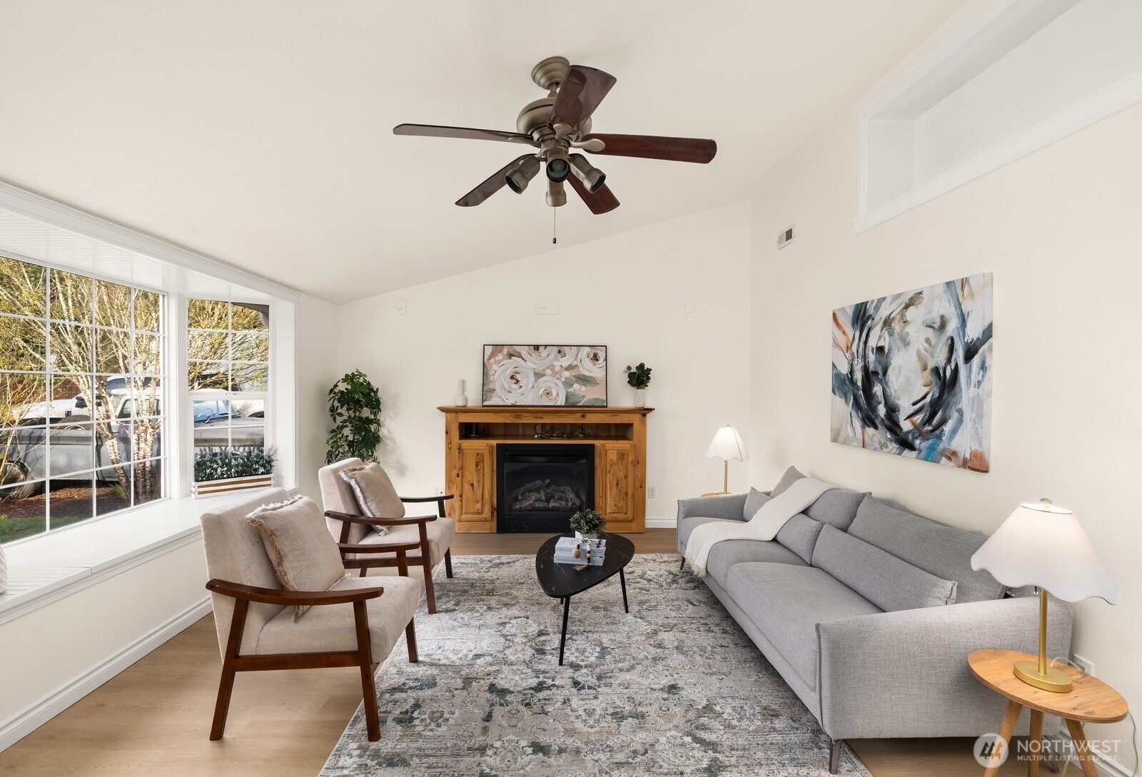 506 Train Street Southeast Orting, WA 98360 - Photo 7 of 24 a living room with furniture a fireplace and a floor to ceiling window