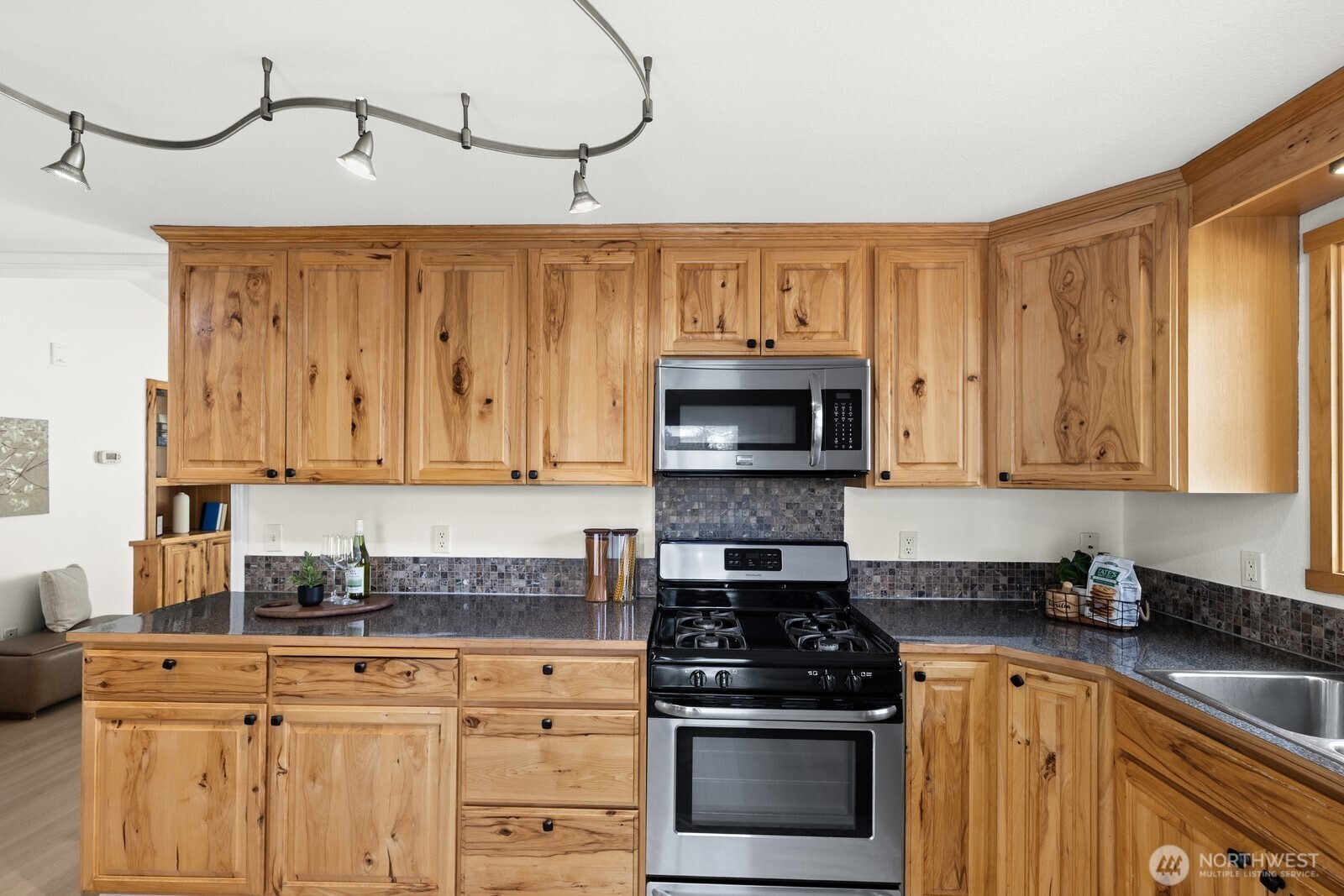 506 Train Street Southeast Orting, WA 98360 - Photo 10 of 24 a kitchen with stainless steel appliances granite countertop a stove a sink and white cabinets