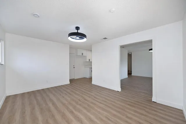 a kitchen with a sink cabinets stainless steel appliances and a window