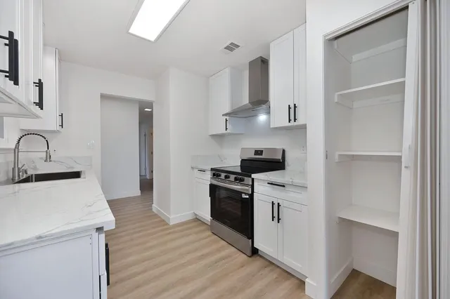 a kitchen with a sink stove and cabinets
