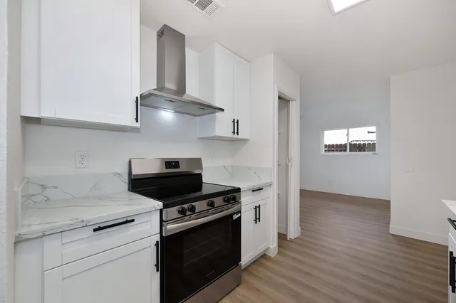 a bathroom with a toilet a sink a mirror a bathtub and vanity