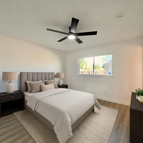 a bedroom with bed and a window