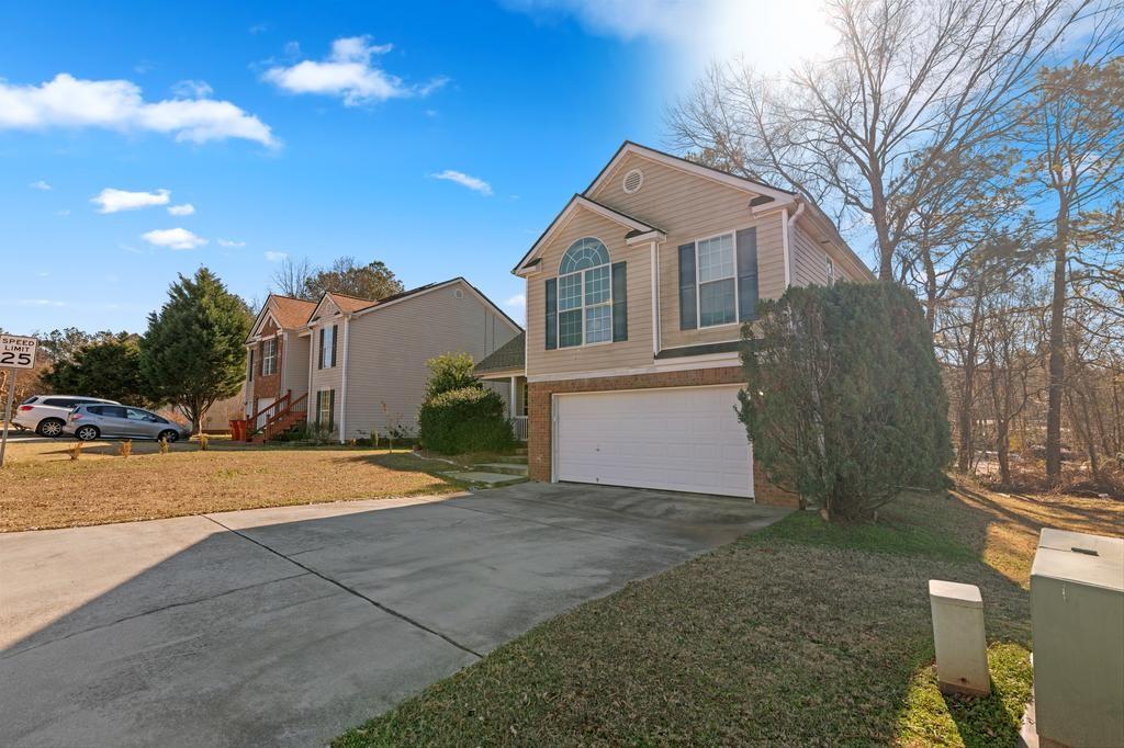 5914 Waggoner Court Rex, GA 30273 - Photo 2 of 21 a front view of a house with a yard and garage