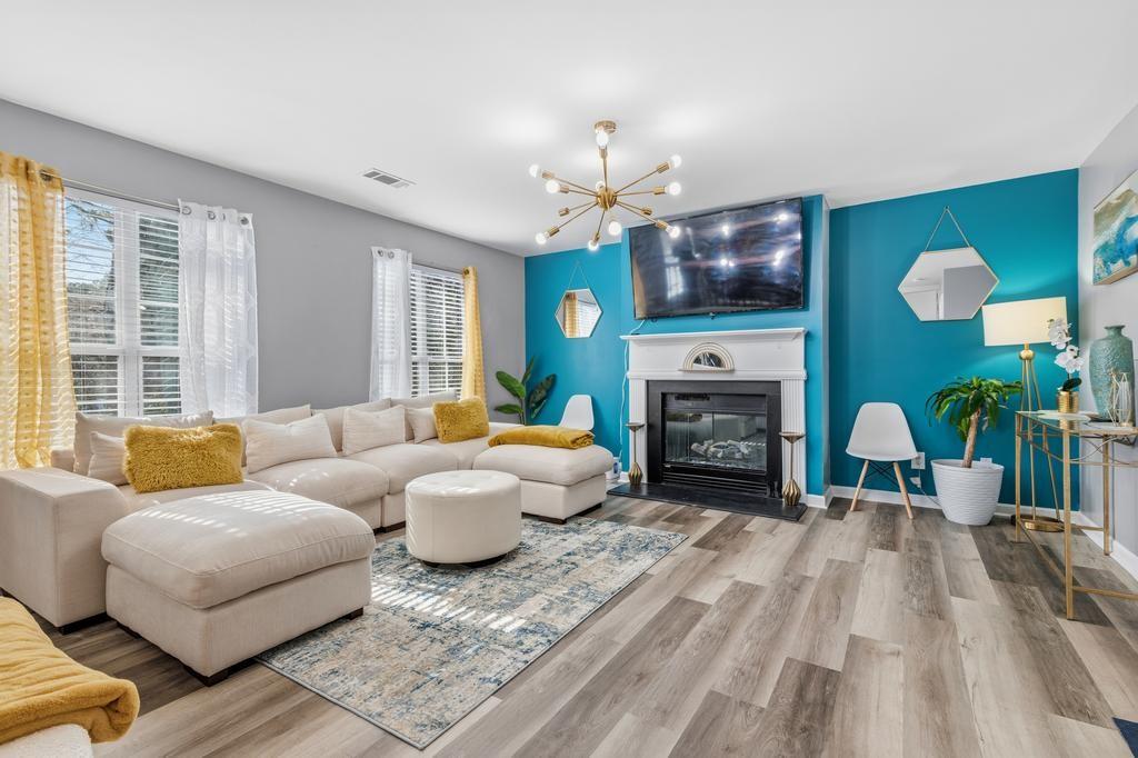 5914 Waggoner Court Rex, GA 30273 - Photo 7 of 21 a living room with furniture a fireplace and a flat screen tv