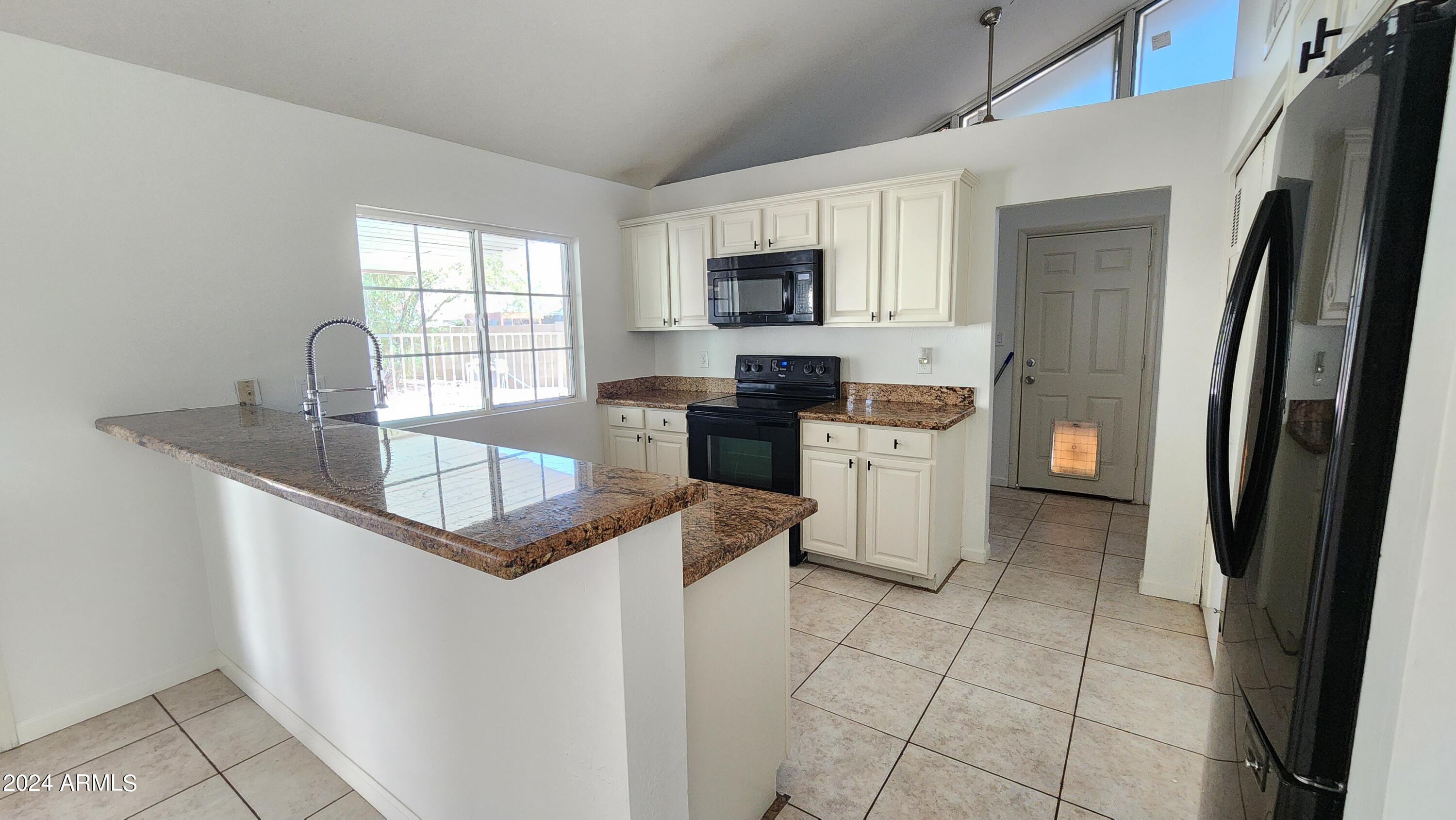 3017 West Yucca Street Phoenix, AZ 85029 - Photo 15 of 32 a kitchen with stainless steel appliances granite countertop a refrigerator sink and stove