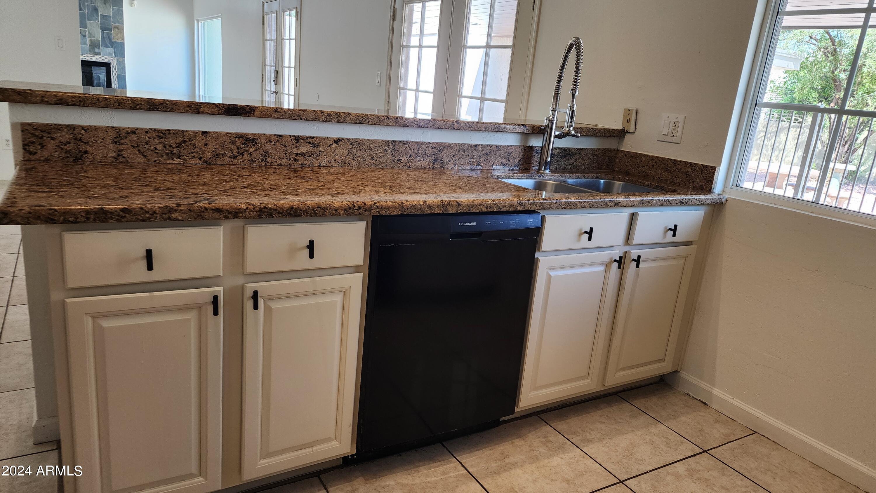 3017 West Yucca Street Phoenix, AZ 85029 - Photo 17 of 32 a bathroom with a granite countertop sink and a mirror