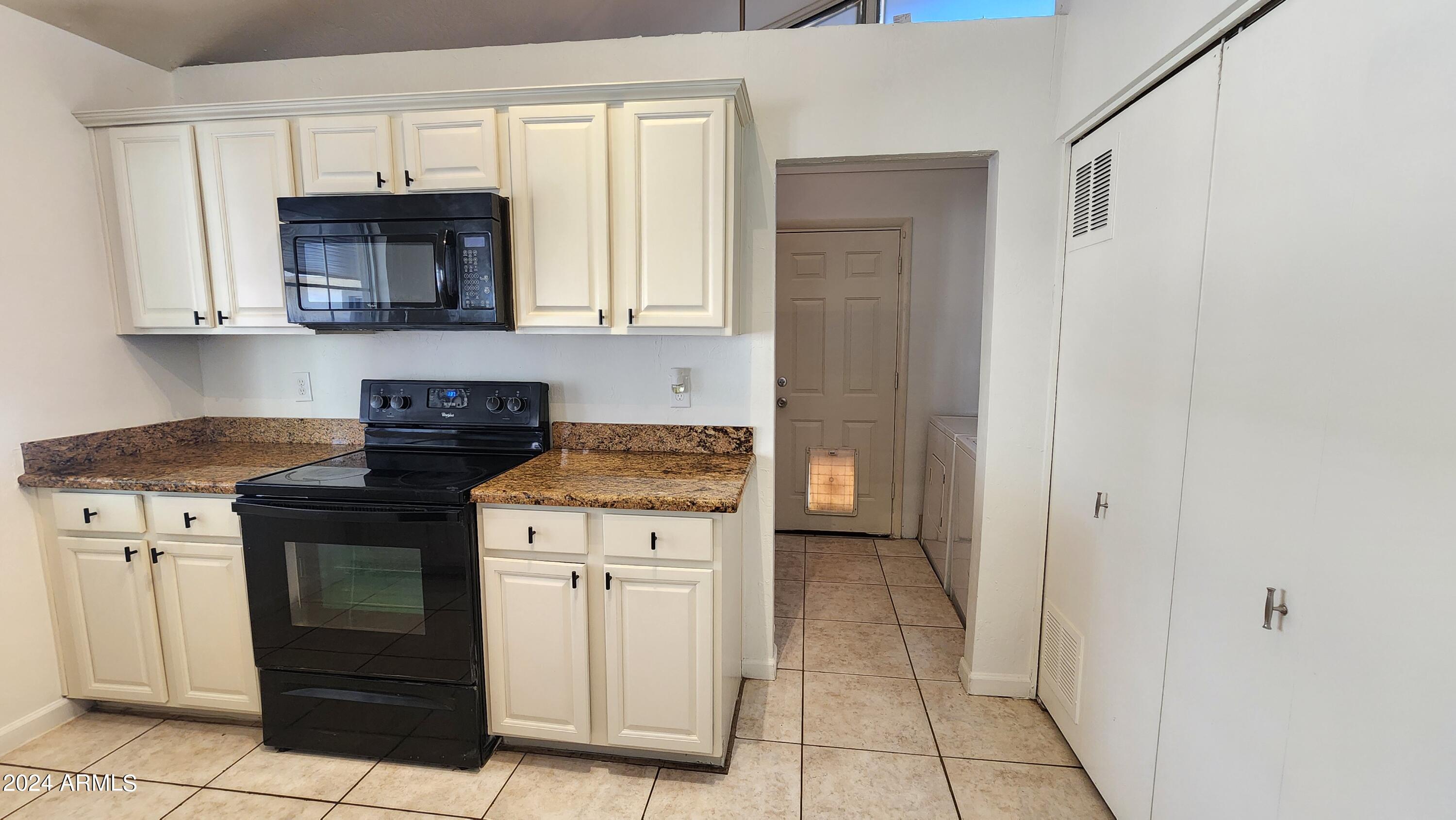 3017 West Yucca Street Phoenix, AZ 85029 - Photo 18 of 32 a kitchen with a stove and a microwave