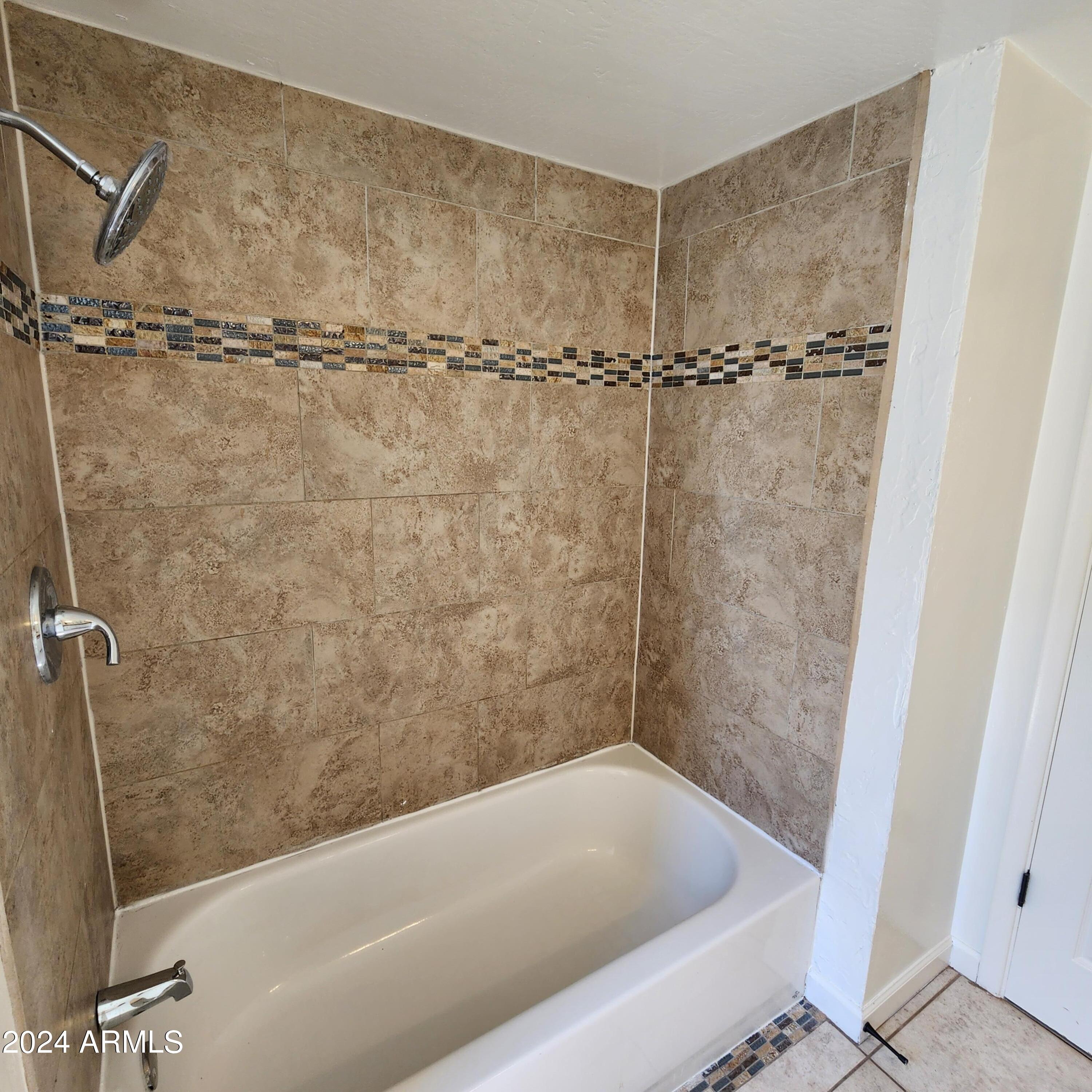 3017 West Yucca Street Phoenix, AZ 85029 - Photo 26 of 32 a bathroom with a shower and a bathtub