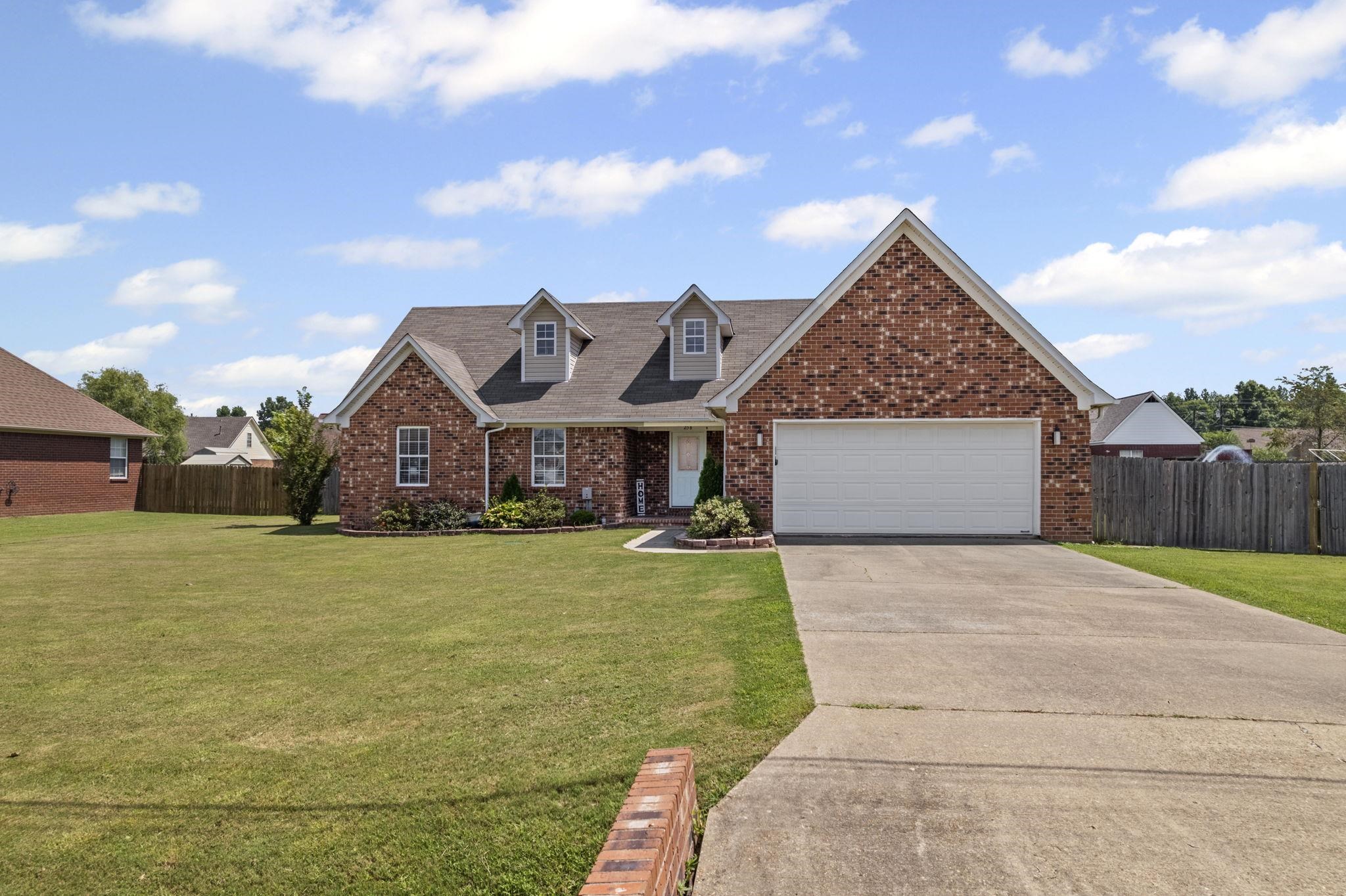 256 Azalea Drive Atoka, TN 38004 - Photo 2 of 39 View of front of home with brick siding, driveway, and an attached garage