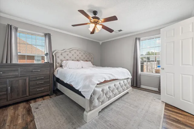 a bedroom with a large bed and a window