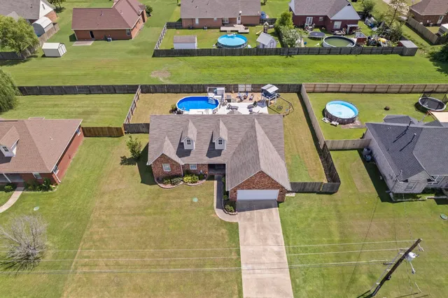 an aerial view of a house with a big yard