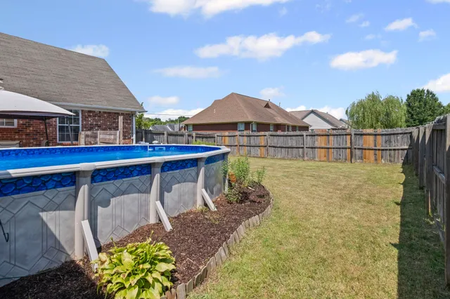 a view of a house with pool and chairs
