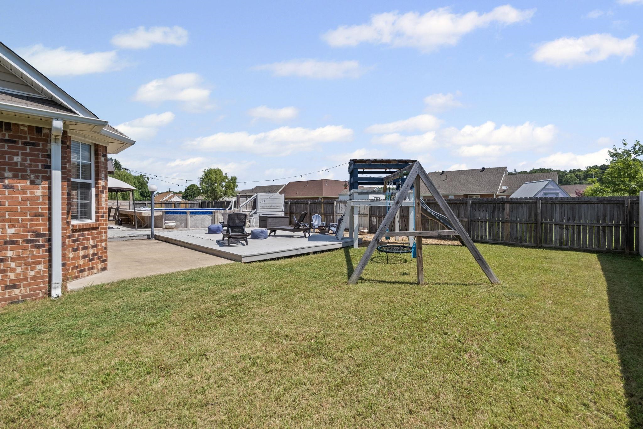 256 Azalea Drive Atoka, TN 38004 - Photo 36 of 39 Fenced backyard with a playground and a patio area