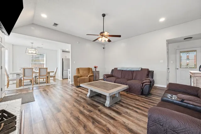 a living room with furniture and a chandelier