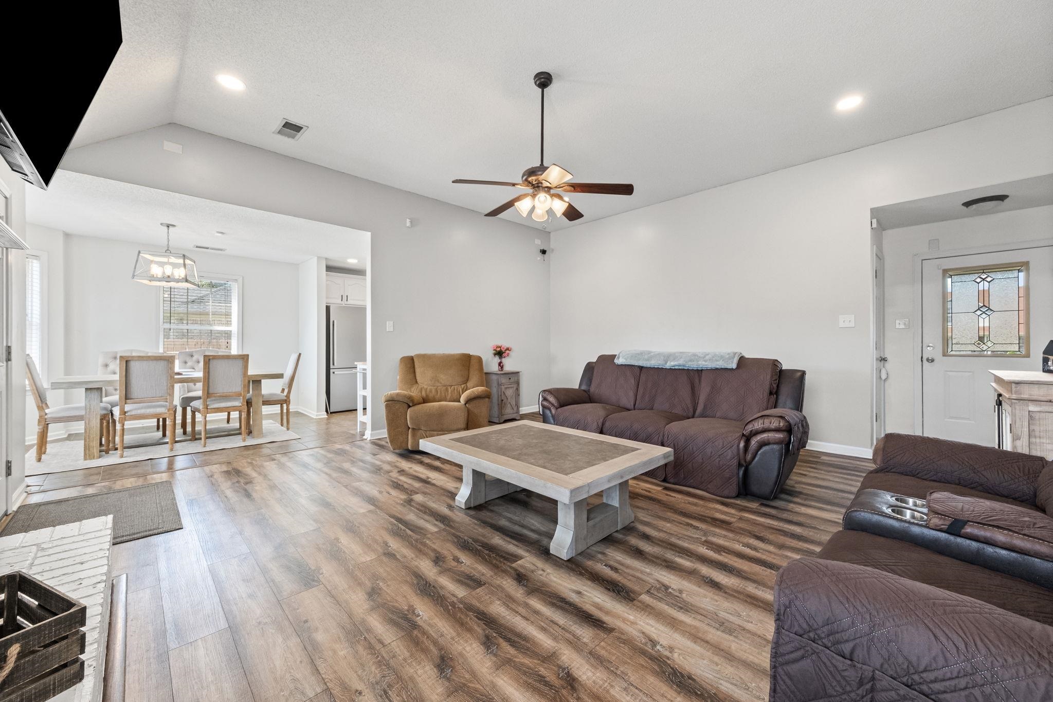 256 Azalea Drive Atoka, TN 38004 - Photo 10 of 39 Living room with dark wood-style floors, recessed lighting, a ceiling fan, lofted ceiling, and a chandelier