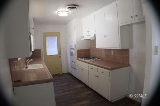 247 West Graaf Avenue Ridgecrest, CA 93555 - Photo 10 of 20 a kitchen with a stove and a refrigerator