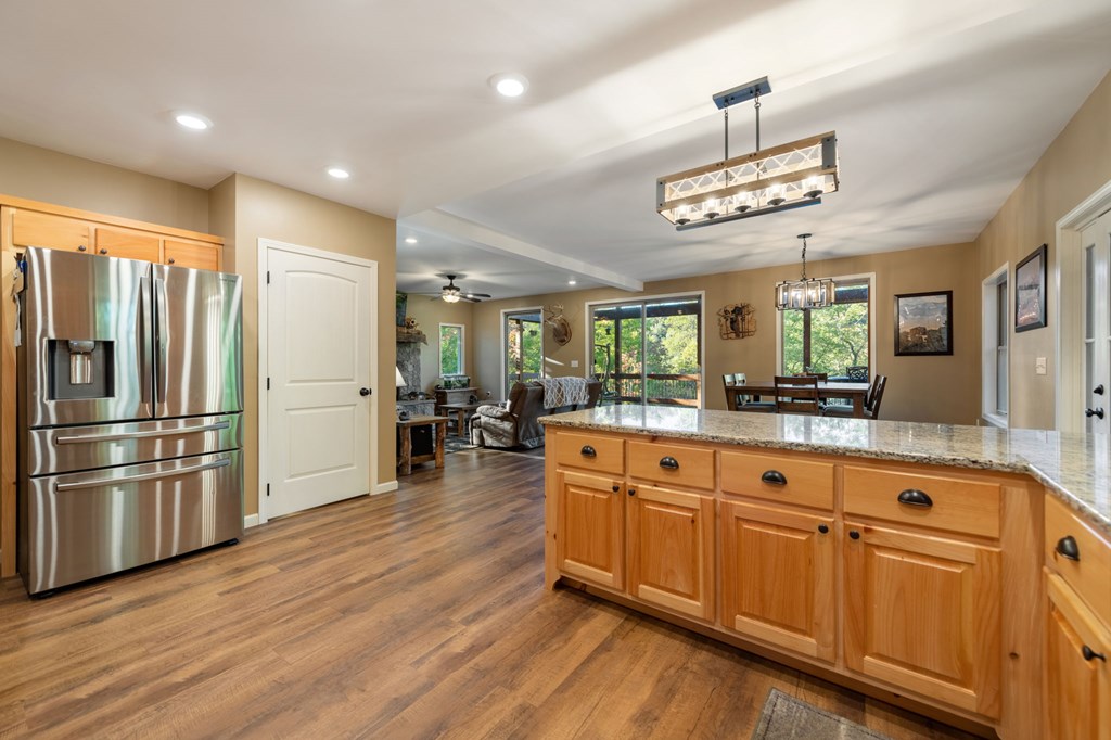 44 Lower Toccoa Hills Road Blue Ridge, GA 30513 - Photo 11 of 36 a kitchen with stainless steel appliances granite countertop a refrigerator a sink dishwasher a stove and white cabinets with wooden floor