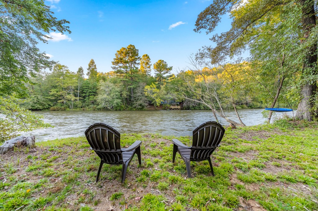 44 Lower Toccoa Hills Road Blue Ridge, GA 30513 - Photo 2 of 36 a backyard of a house with table and chairs