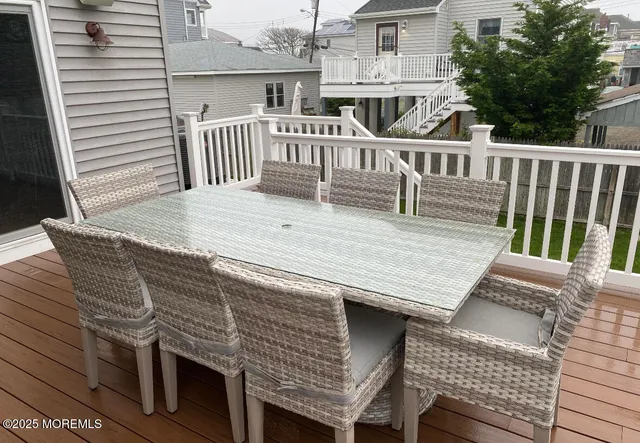 a view of a roof deck with chair and wooden floor