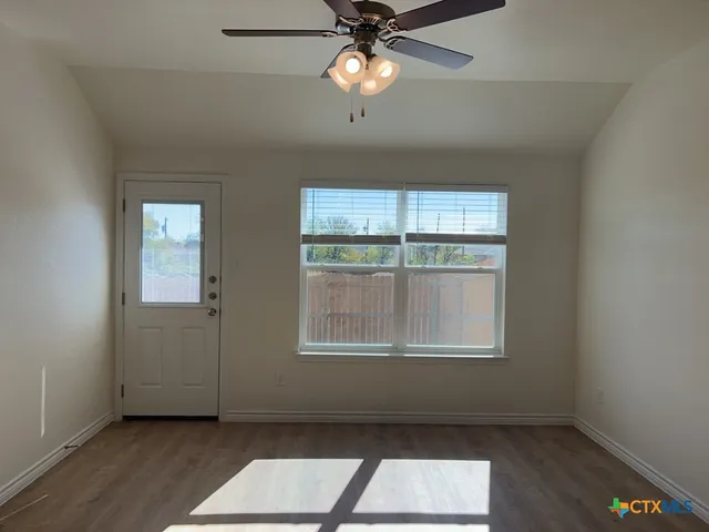 a view of an empty room with a window
