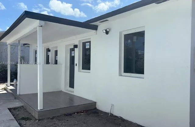 image of a hallway with wooden floor and a living room