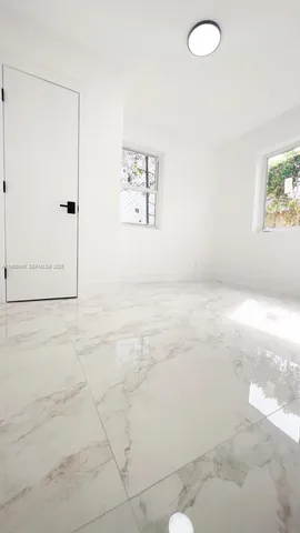 a view of a room with window and wooden floor