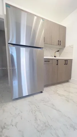 a view of kitchen with refrigerator