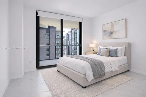 a spacious bedroom with a bed and a painting on the wall