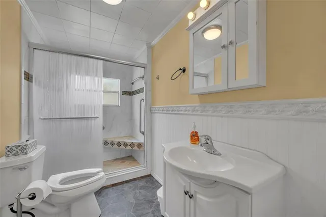 a bathroom with a sink toilet and shower