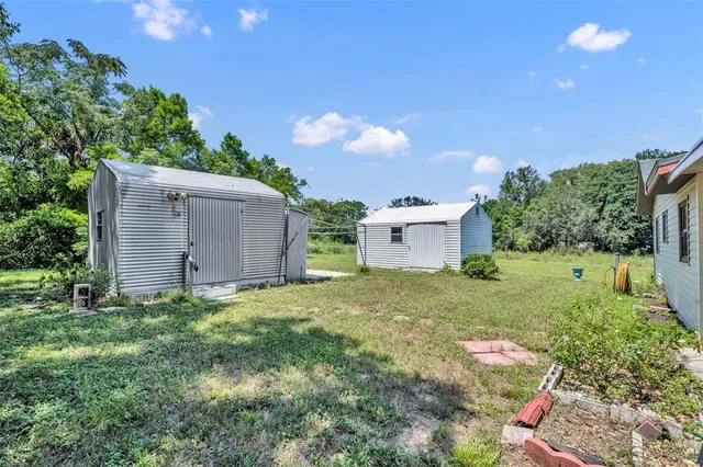 a backyard of a house with plants and outdoor seating