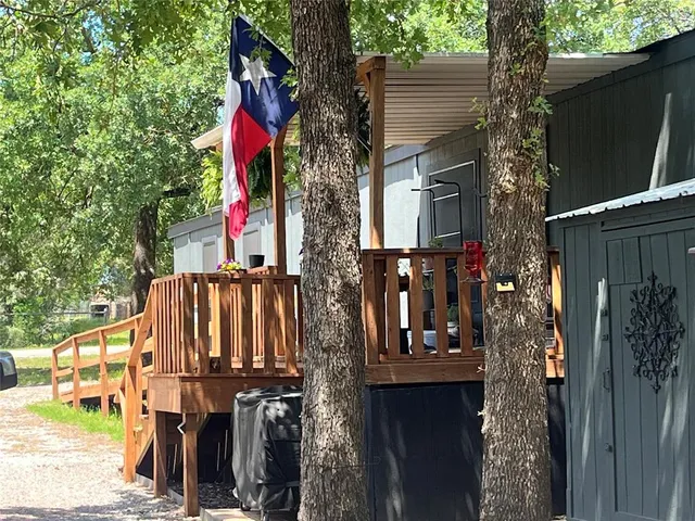 a kitchen with a refrigerator and wooden floor