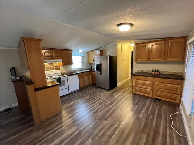 a view of a livingroom with furniture wooden floor and window
