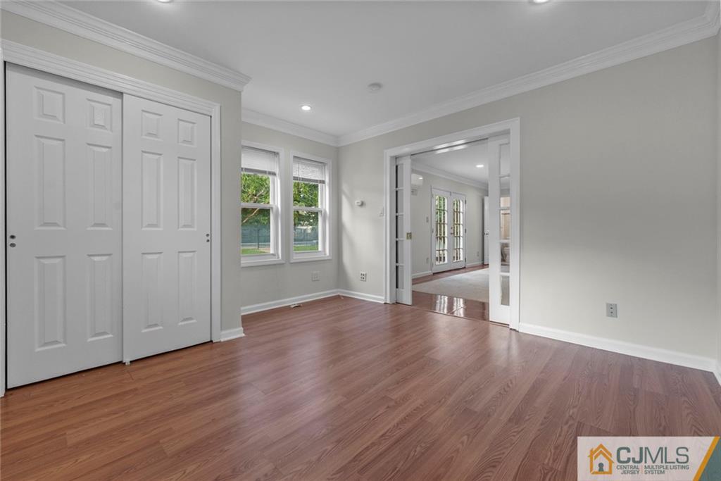 33 Hazel Avenue Edison, NJ 08820 - Photo 22 of 52 a view of an empty room with wooden floor and windows