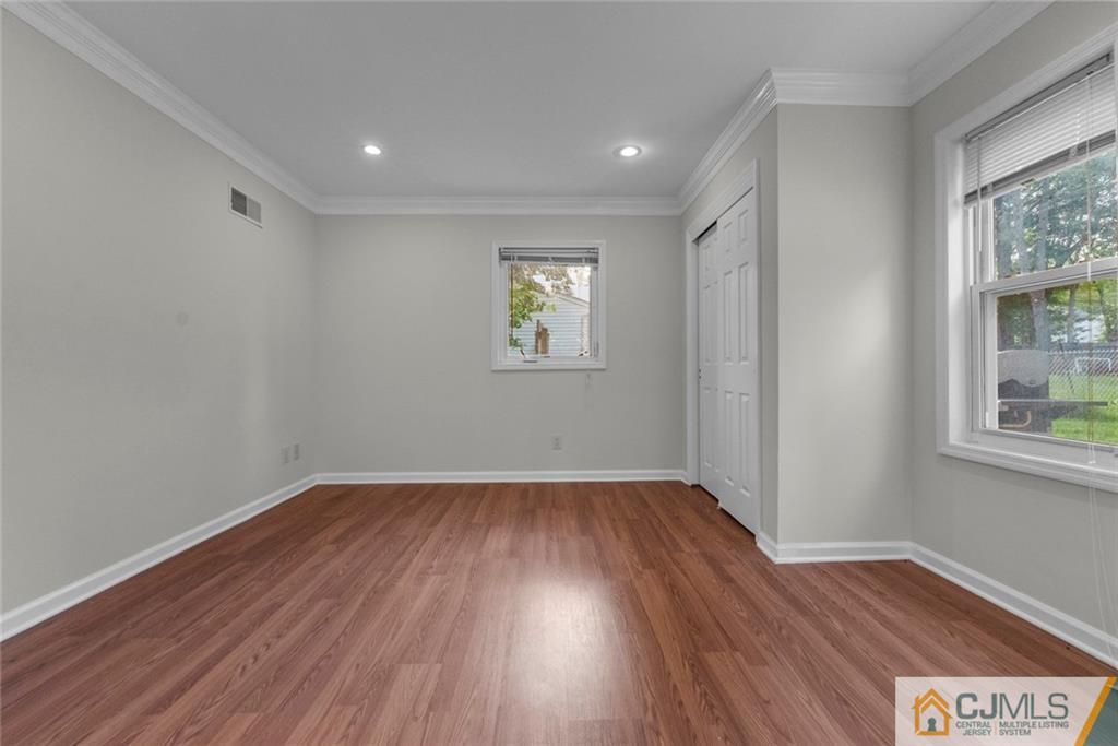 33 Hazel Avenue Edison, NJ 08820 - Photo 23 of 52 an empty room with wooden floor and windows