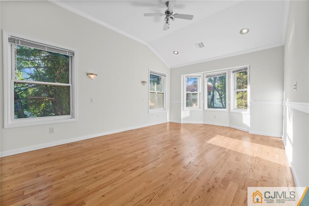 33 Hazel Avenue Edison, NJ 08820 - Photo 25 of 52 a view of an empty room with a window and wooden floor