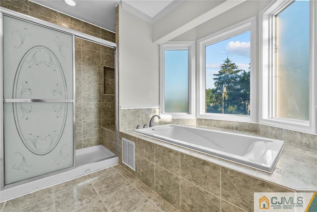 33 Hazel Avenue Edison, NJ 08820 - Photo 29 of 52 a bathroom with a tub a sink and a window