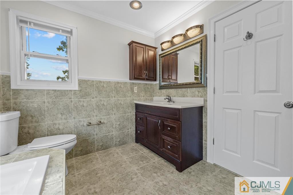 33 Hazel Avenue Edison, NJ 08820 - Photo 30 of 52 a bathroom with a sink vanity and toilet