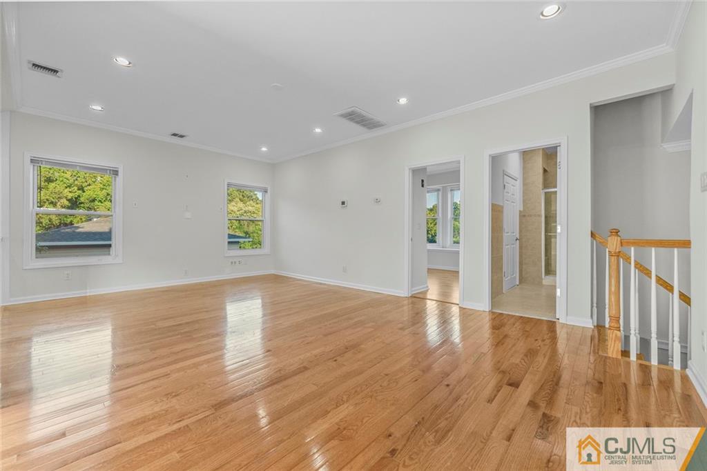 33 Hazel Avenue Edison, NJ 08820 - Photo 32 of 52 a view of an empty room with wooden floor and windows