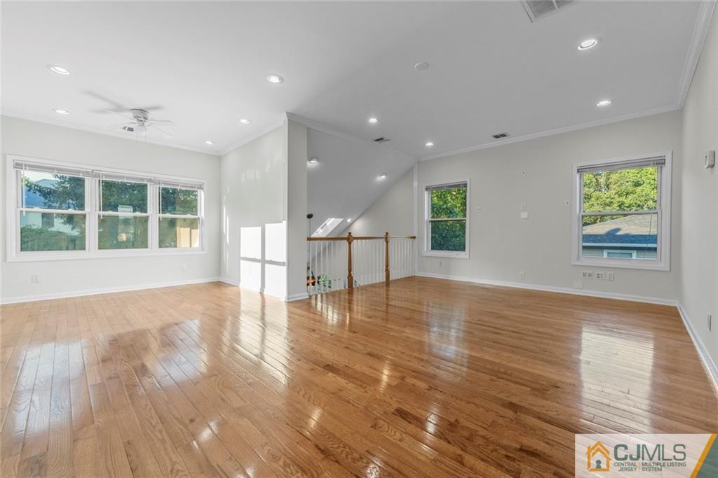 33 Hazel Avenue Edison, NJ 08820 - Photo 33 of 52 a view of empty room with wooden floor and windows