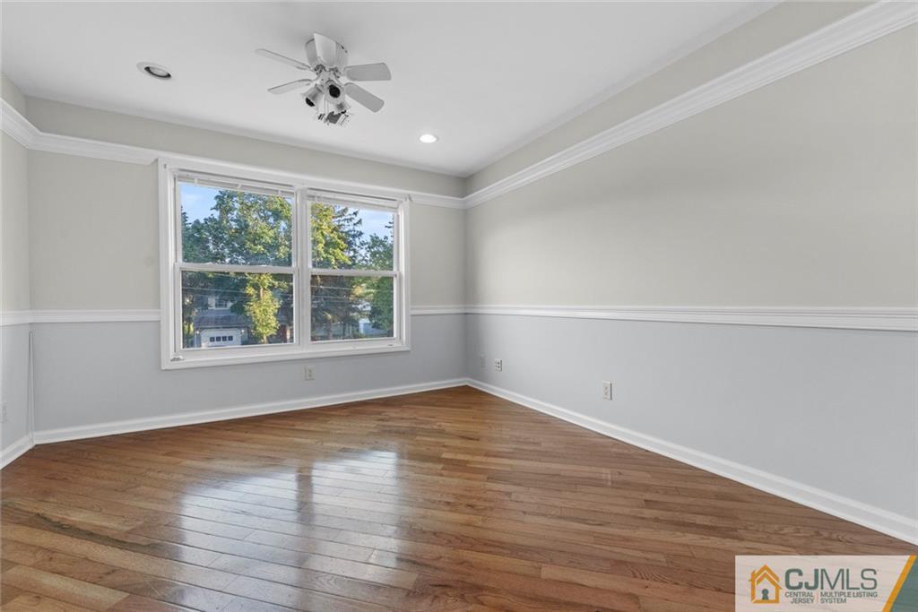 33 Hazel Avenue Edison, NJ 08820 - Photo 37 of 52 an empty room with wooden floor and windows