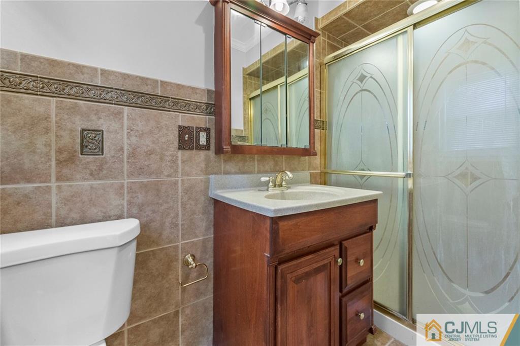 33 Hazel Avenue Edison, NJ 08820 - Photo 42 of 52 a bathroom with a sink a toilet and shower