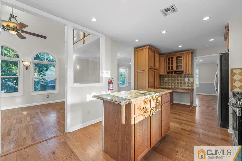 33 Hazel Avenue Edison, NJ 08820 - Photo 8 of 52 a kitchen with a stove and a wooden floor
