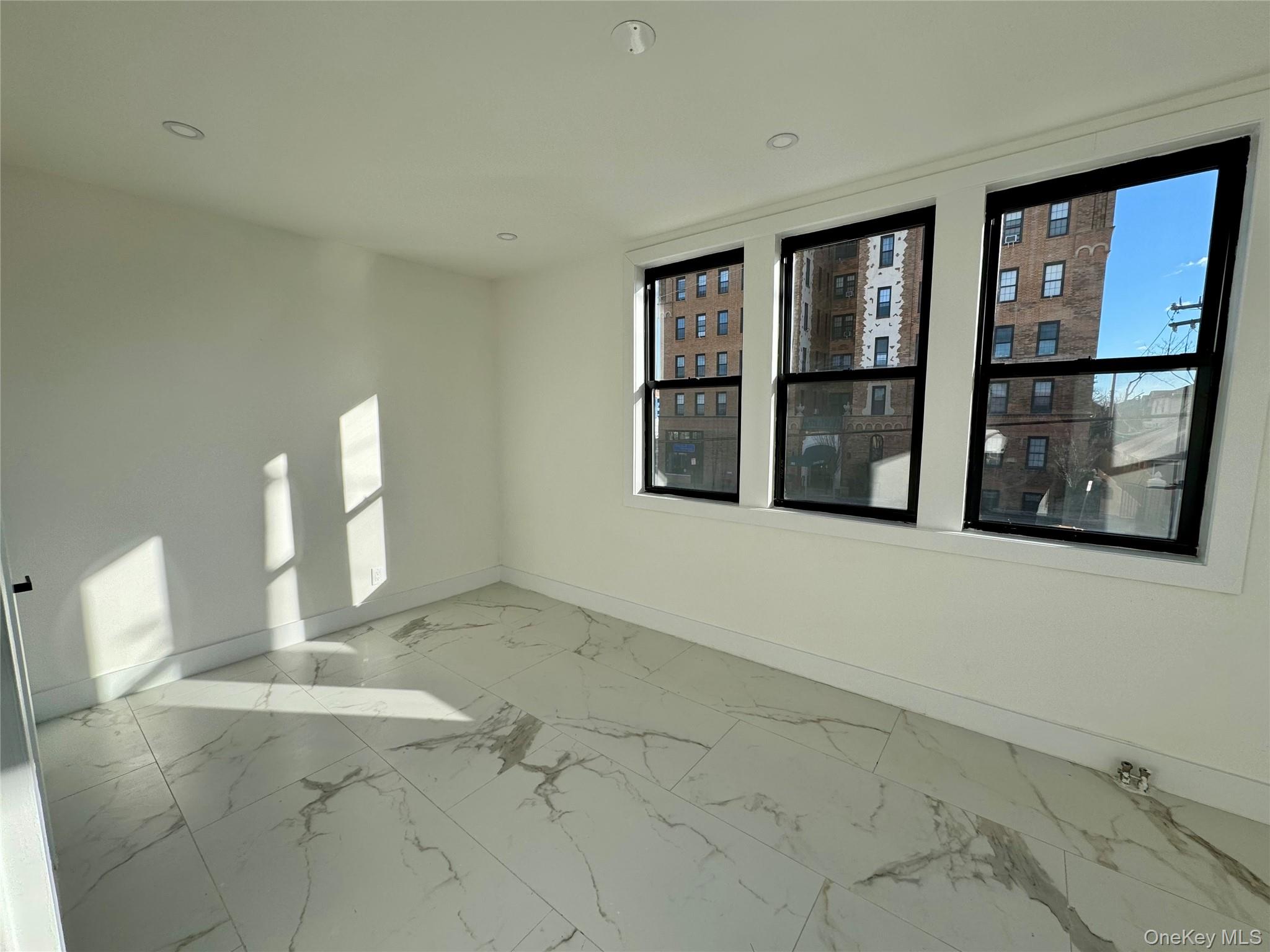 315 Riverside Boulevard, Unit 1 Long Beach, NY 11561 - Photo 5 of 9 a view of an empty room with a window