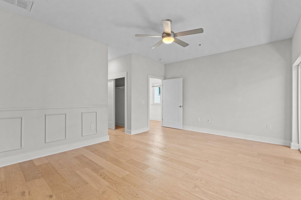 2827 Manor Road, Unit 2201 Austin, TX 78722 - Photo 29 of 40 Spacious room featuring light wood-finish flooring, white baseboard trim, and light gray wall paint