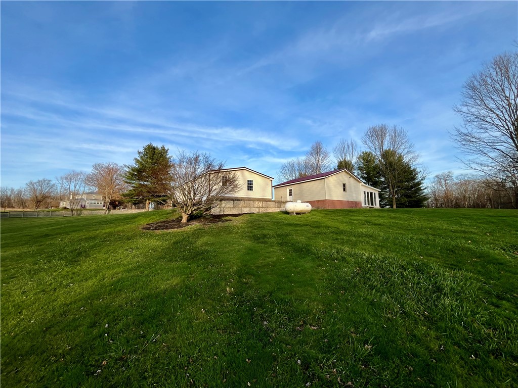 11834 Tellier Road Wolcott, NY 14590 - Photo 13 of 42 Rear exterior of home and garage