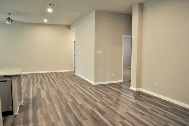 a view of hallway with wooden floor