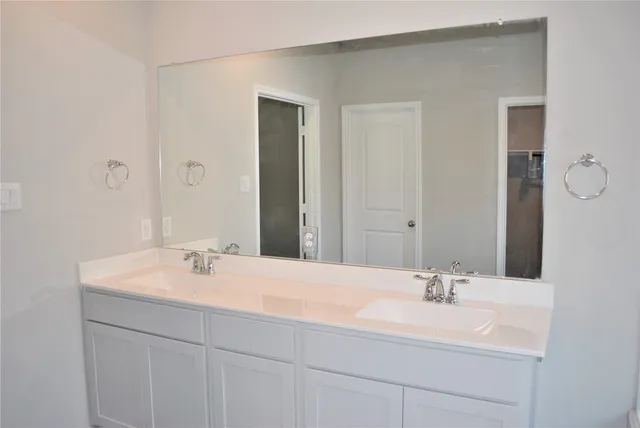 a white bath tub sitting next to a white sink