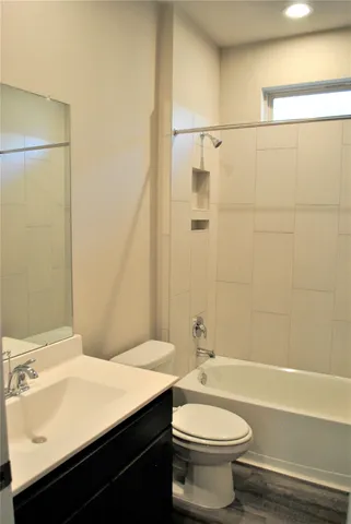 a bathroom with a sink a toilet and bathtub