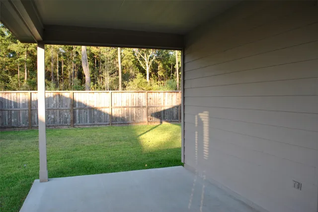 a view of a backyard with potted plants